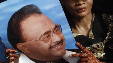 A supporter of Altaf Hussain holds his picture during a protest rally in Karachi, on 20 May 2013.