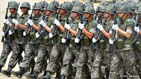 South Korean soldiers march during a ceremony for a re-enactment of the battle of Chuncheon at the beginning of the Korean War