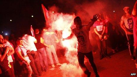 People celebrate outside the presidential palace in Cairo on 3 July 2013