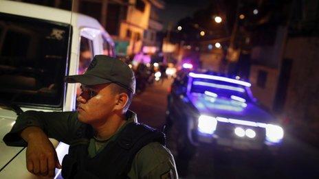 A Venezuelan soldier stands during a patrol at the slum of Petare in Caracas May 23