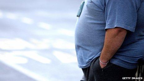 Large man standing at bus stop