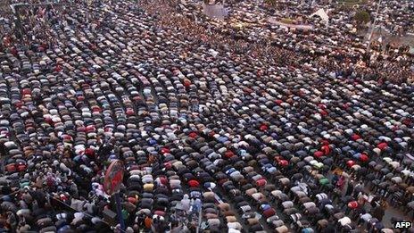 Protesters pray in Tahrir Square in February 2011