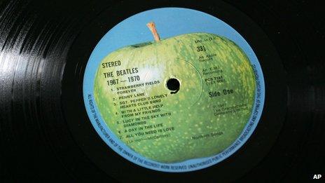 A Beatles vinyl with their whole green apple logo