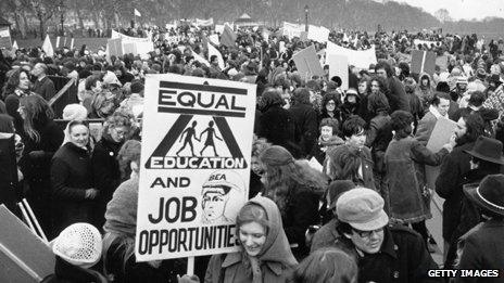 A woman holds an "Equal education and job opportunities" sign at a Women's Liberation Movement demonstration in 1971