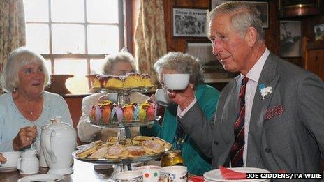 Prince Charles enjoys a cup of tea with members of the Tuesday Club during a visit to the Prince of Wales Inn, Bridgend