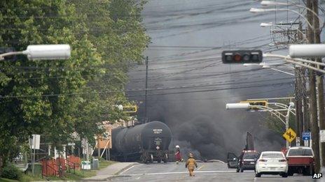 Smoke rises from railway cars carrying crude oil that derailed in Lac Megantic, Quebec, Canada, 6 July 2013