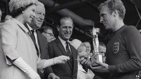 Bobby Moore receives the World Cup from the Queen in 1966