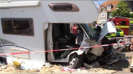 Police cordon surrounds crumpled front of motor home