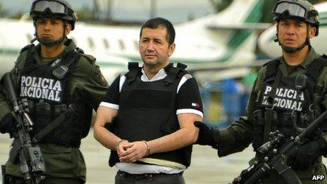 Colombian drug trafficker Daniel Barrera is escorted by policemen before being deported to the US, on 9 July in Bogota