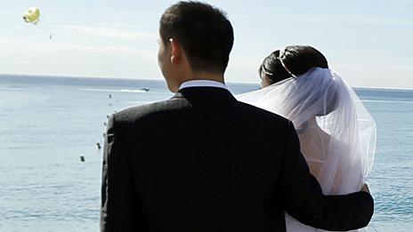 A Chinese couple pose for a wedding photograph on the Promenade des Anglais in Nice, France