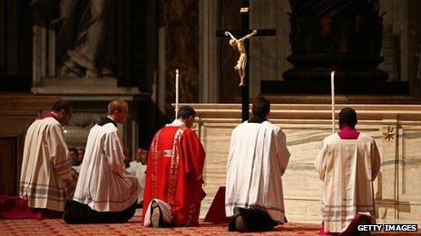 Bishops and priests pray under a crucifix (29 March 2013)