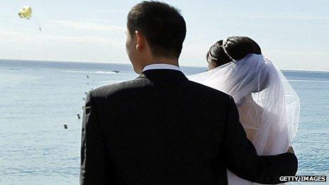 A Chinese couple pose for a wedding photograph on the Promenade des Anglais in Nice, France