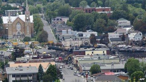 Scorched oil tankers remain at the train derailment site in Lac-Megantic, Canada, on 10 July 10 2013