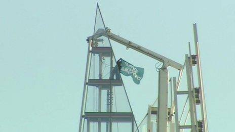 A protester unveiled a Greenpeace flag at the skyscraper's summit