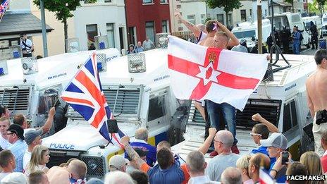 Men stand on police landrover