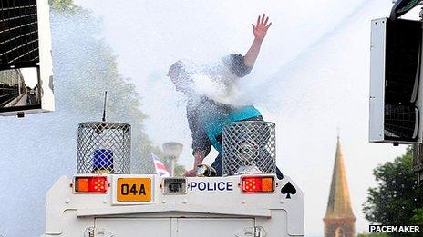 Mon on police Land Rover hit with water cannon jet