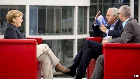 German Chancellor Angela Merkel (L) during her interview with German public broadcaster ARD