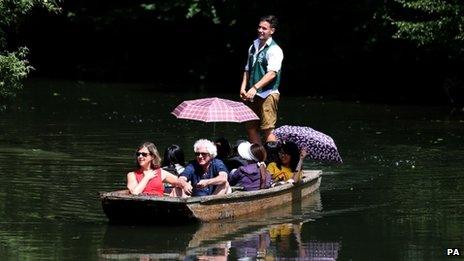 Punters enjoy the summer sunshine as they make their way along the river Cam in Cambridge on 15 July 2013