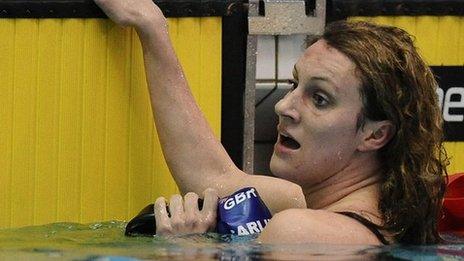 Jazz Carlin hangs on to the side of the pool after completing a race