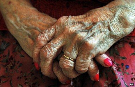 An elderly person's hands