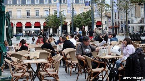 Lots of tables outside a French restaurant cafe