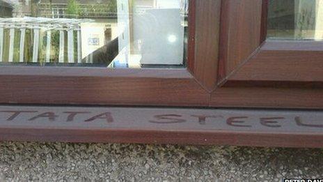 Words Tata Steel written in dust on external window sill at Port Talbot home of Peter Davies