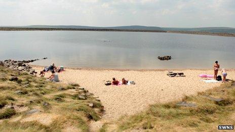 Sunbathers at Gaddings Dam reservoir, near Todmorden