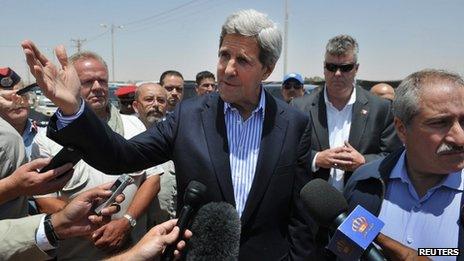 Secretary of State John Kerry speaks to reporters as Jordanian Foreign Minister Nasser Judeh (R) looks on during a visit to Zaatari refugee camp, near the Jordanian city of Mafraq July 18, 2013