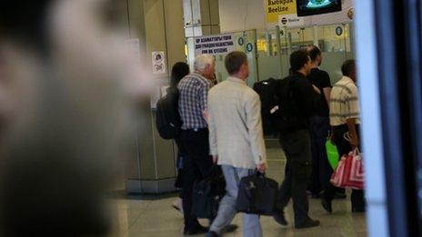 Mohammed looks on as passengers leave airport