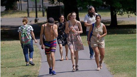 People walk in a park in central London