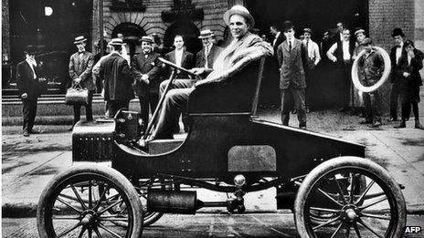 Henry Ford, US car manufacturer, poses in his new T Ford model in front of his car plant in Detroit in the early 1900s