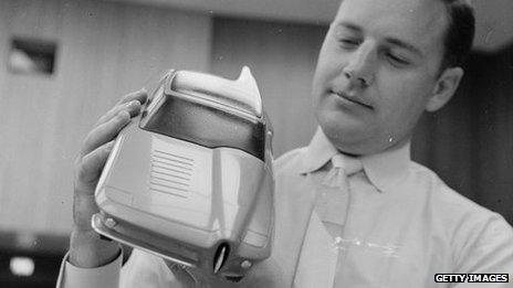 An employee at General Motors in Detroit shows a prototype of a car in 1955