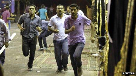 Members of the Muslim Brotherhood and supporters of ousted Egyptian President Morsi run during a clash with anti-Morsi protesters in Alexandria (7 July)