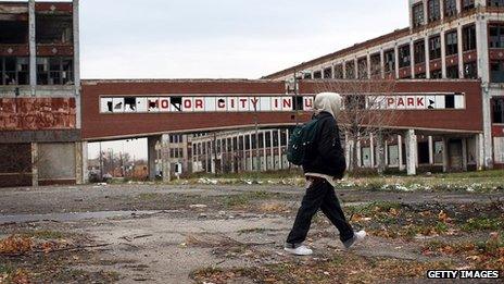 A person walks past the remains of the Packard Motor Car Company building in Detroit, November 2008