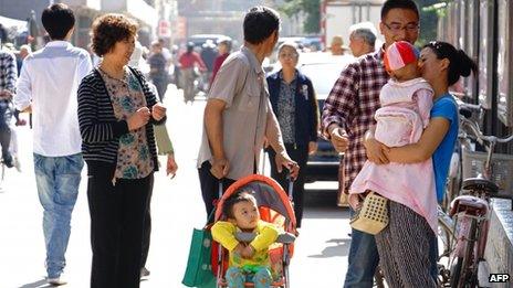 Residents take shelter on a street after an earthquake in downtown Dingxi in northwest China's Gansu province on 22 July 2013