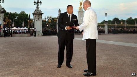 The Queen's senior page Philip Rhodes is given the document