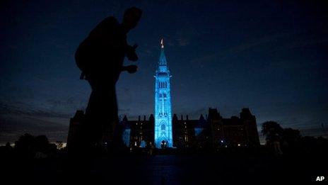 The Peace tower and Parliament buildings in Ottawa, Ontario are illuminated in blue to celebrate the birth of the royal baby