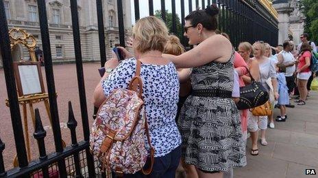 Members of the public taking pictures of the official announcement that the Duke and Duchess of Cambridge have had a baby boy, outside Buckingham Palace