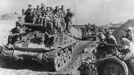 British soldiers travelling on a tank in Korea