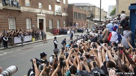 The crowd stretch out to capture pictures as Prince William and Catherine, Duchess of Cambridge show their new-born baby boy to the world