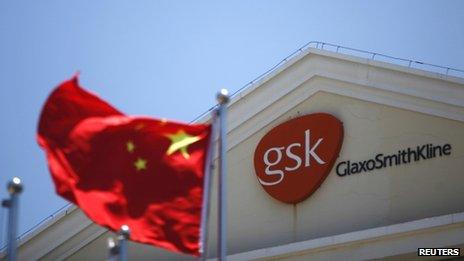 Chinese national flag flutters in front of a GlaxoSmithKline office building in Shanghai