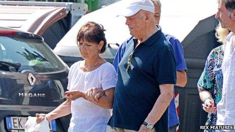 Priebke is seen walking with his carer near his house in Rome