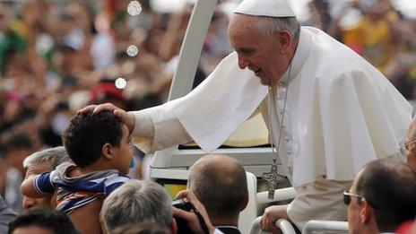 Pope Francis blesses a child in Rio (28 July 2013)