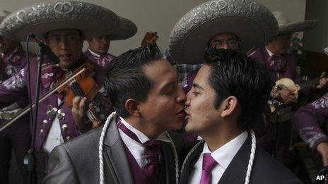 A same-sex couple kisses after getting married in Mexico City on 14 July 2013