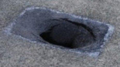 Hole in road