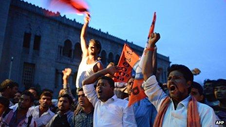 Osmania University students celebrate after the announcement of the separate state of Telangana in Hyderabad on July 30, 2013