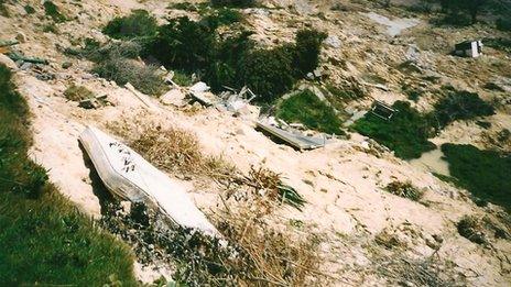 A mattress and some of the remains of Boma Cottage down the side of the cliffs