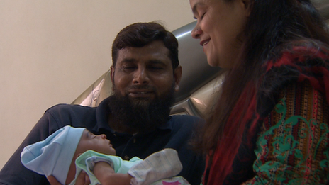 The civil engineer Riaz and his wife Tanzeem hold their newly-adopted child on the TV show.