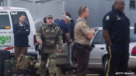 Law-enforcement officials look at an Alabama bunker where a boy was held