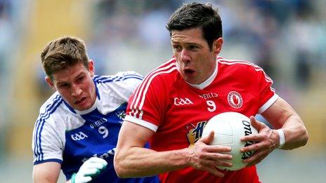 Sean Cavanagh tries to burst away from Darren Hughes at Croke Park